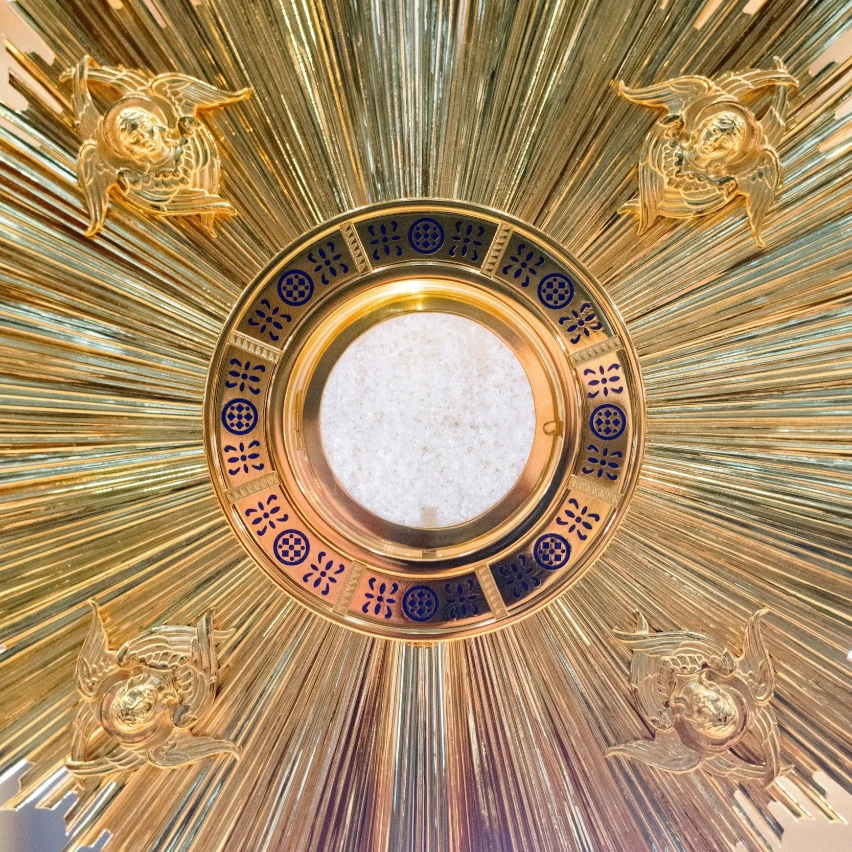 Adoration with the Gold Monstrance holding the blessed body of Christ