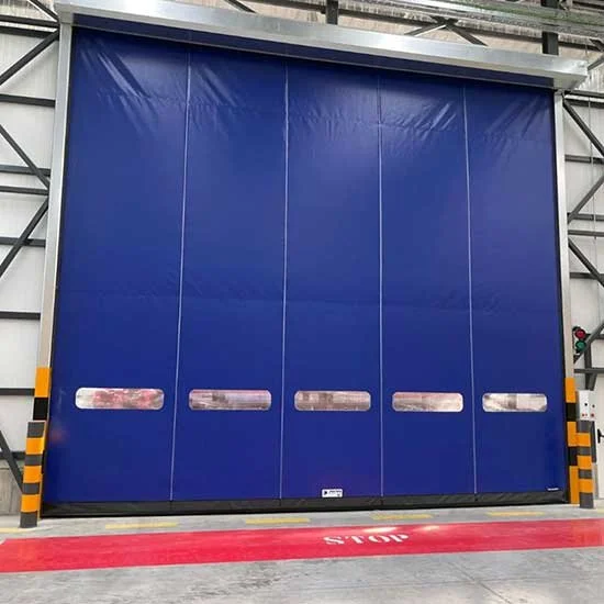 Large blue industrial vehicle door in a warehouse, with yellow and black safety markings on the side, and a red stop line on the floor in front.