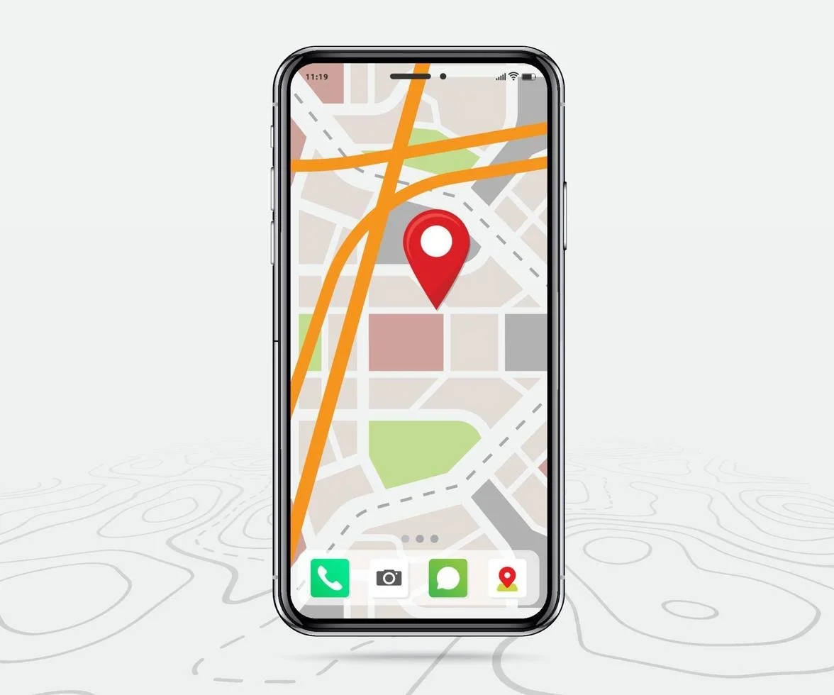 Smartphone displaying a map app with a red location pin on a city map, with streets and green parks visible.