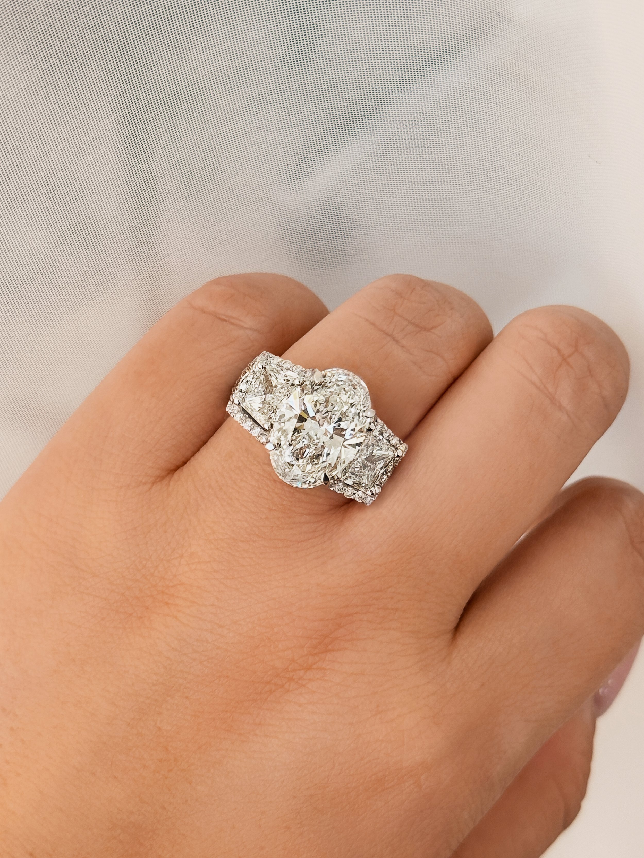 diamond Ring oval cut 5 carat, trapezoid flanked diamonds
