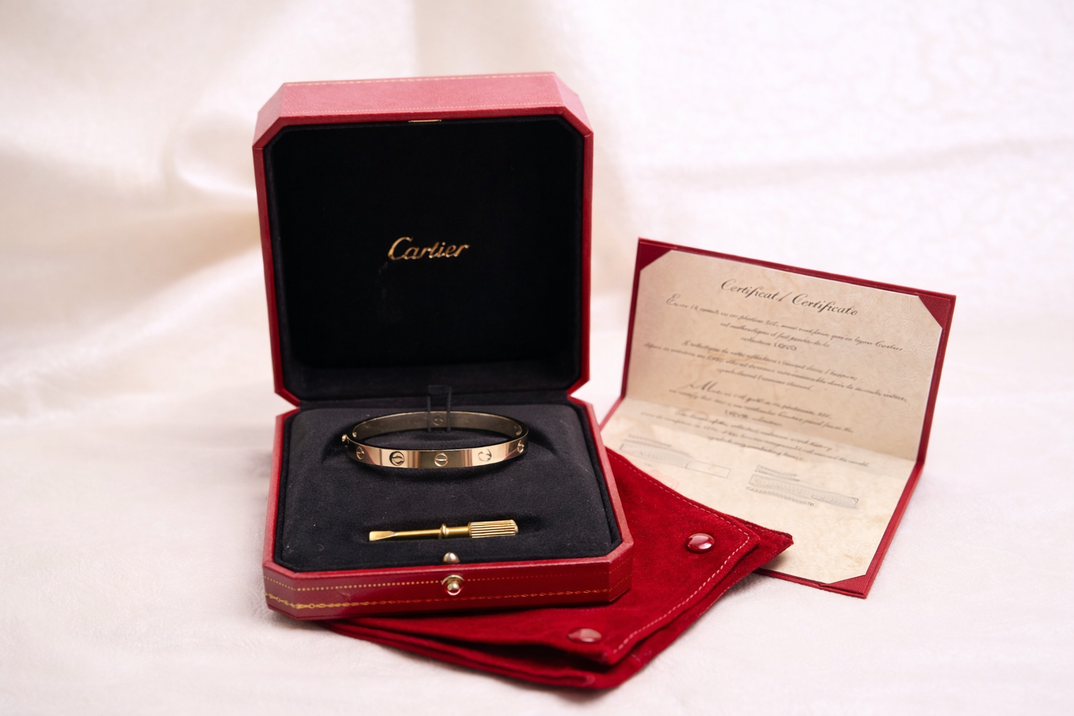 Cartier Love bracelet and certificate display.png