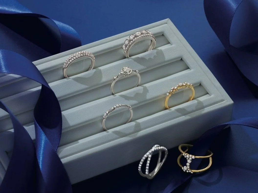 a tray of diamond engagement rings and wedding bands elegantly placed.