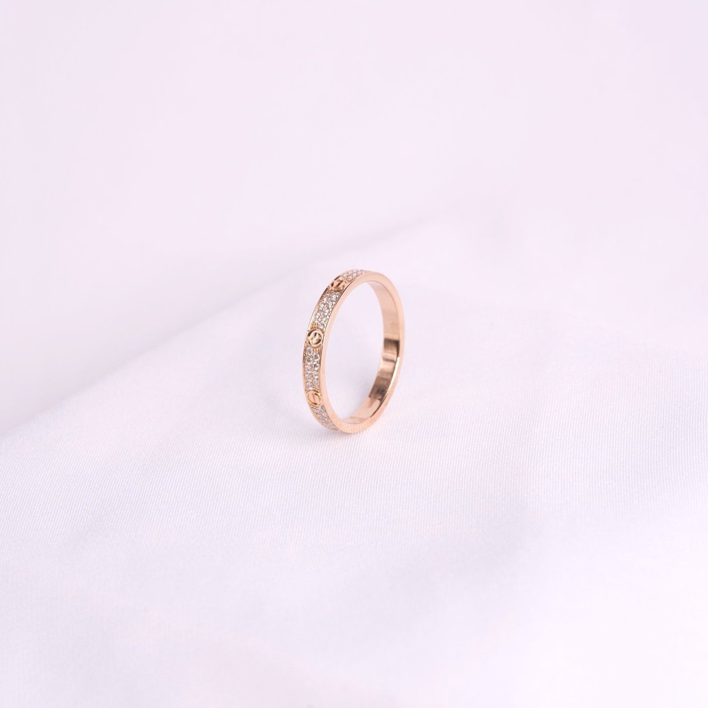 Cartier Love wedding band in rose gold with pavé diamond setting
