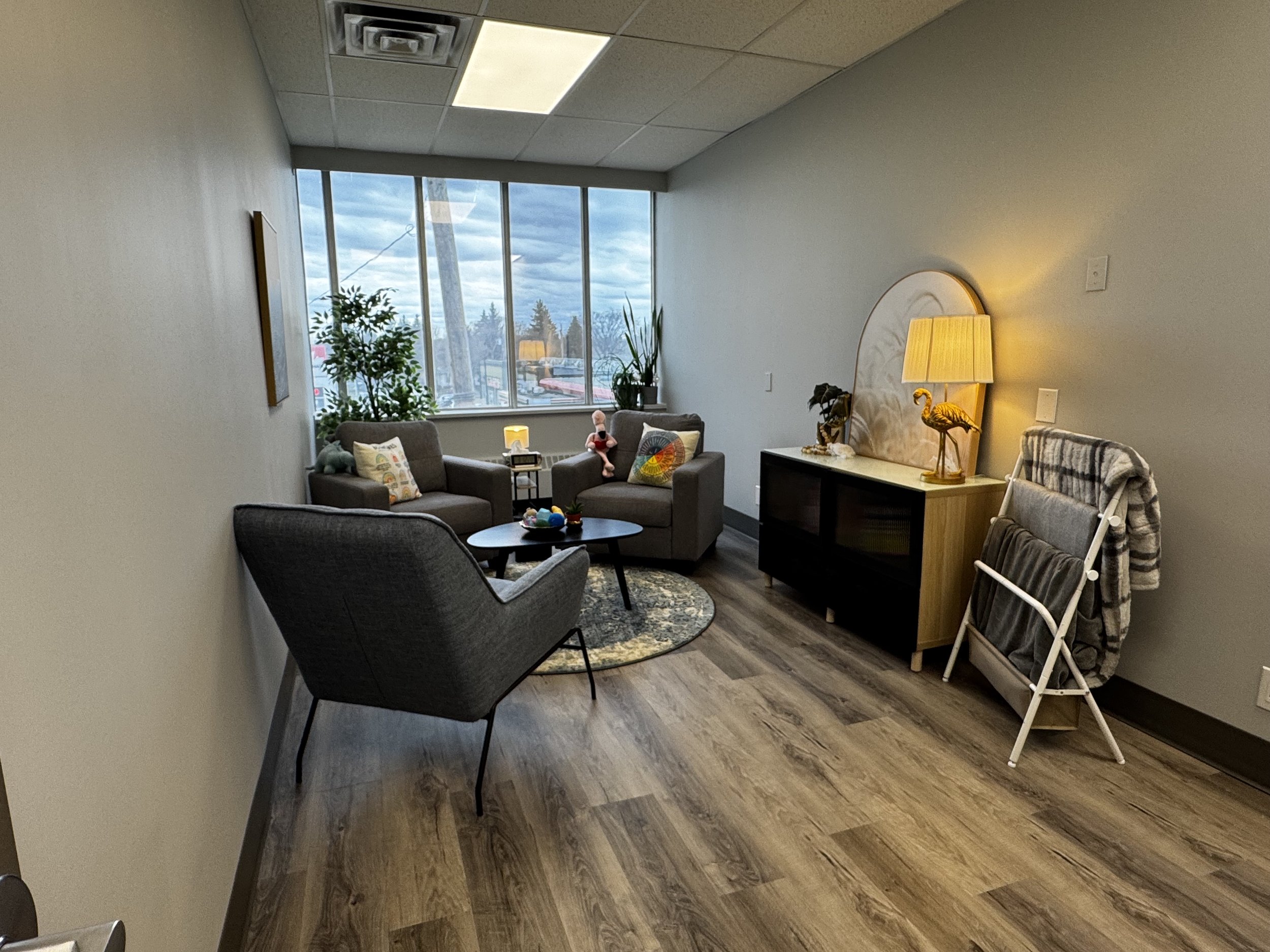 A welcoming therapy office at A Thread of Clarity in West Edmonton, designed to feel calm, safe, and comfortable for in-person counselling sessions.
