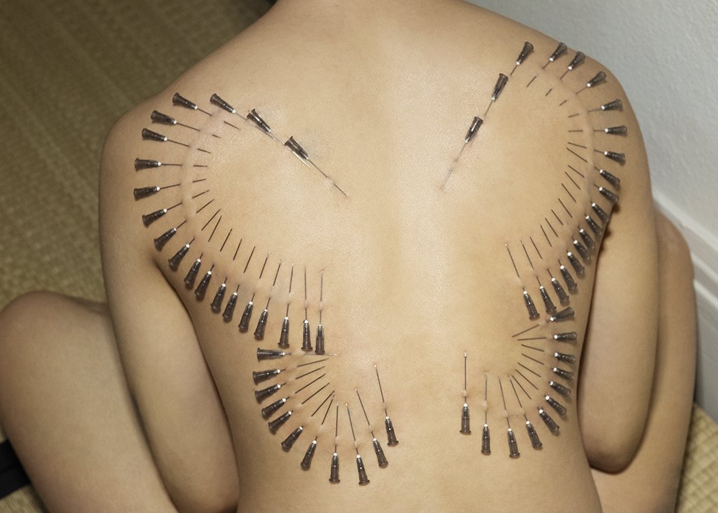 Body modification with medical needles in the shape of a butterfly, direct and created by NYC Dominatrix Saturn Veil 
