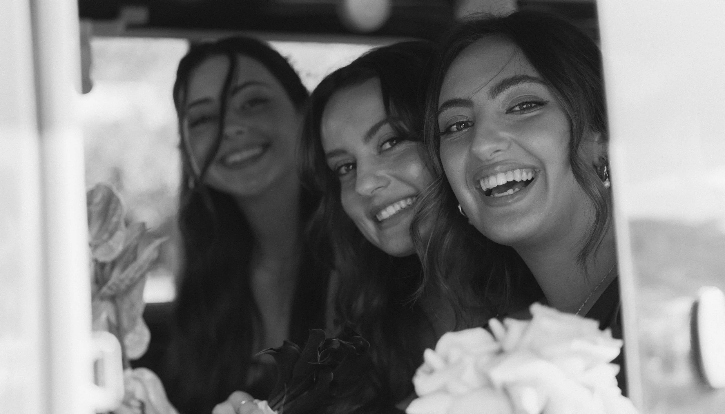Three women smiling and taking a selfie together.