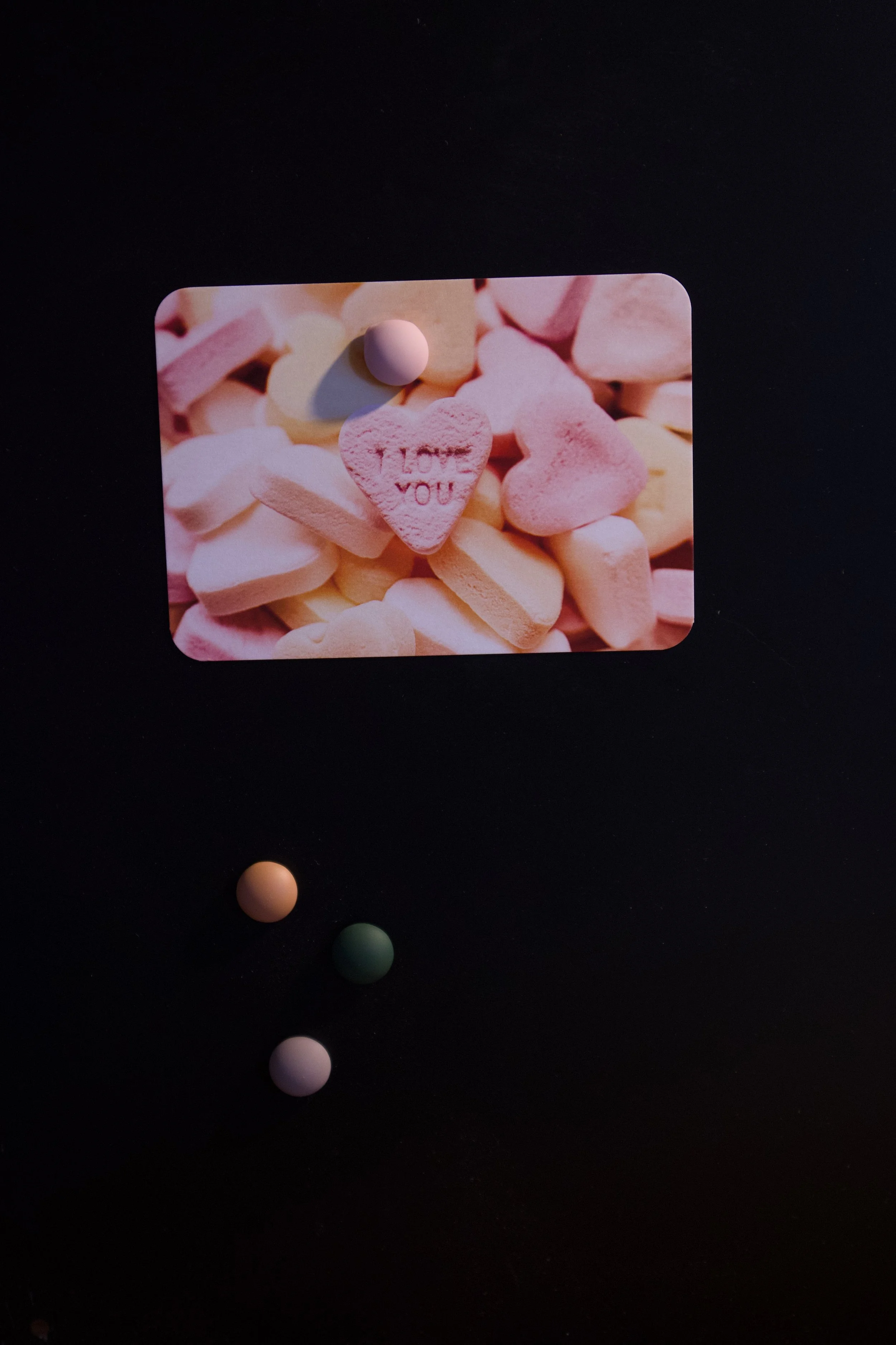Candy Heart Interesting photograph of a pile of pink, orange, and yellow candy hearts with I LOVE YOU embossed into one - Salty Note