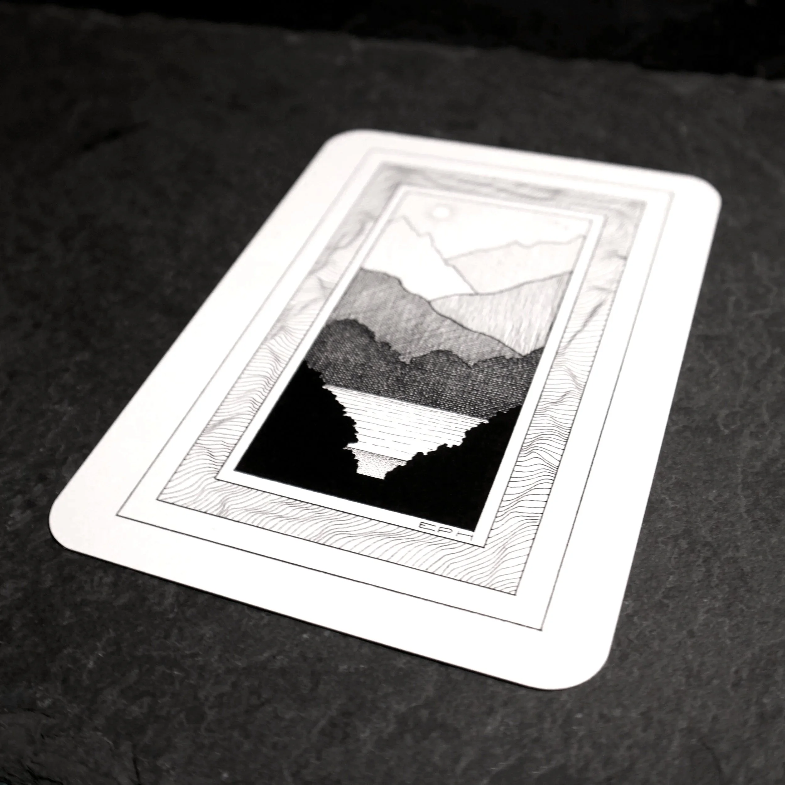 My dad's doodle 1. An intricate black and white illustration of an imagined landscape looking towards a lake, set in an abstract frame - Salty Note