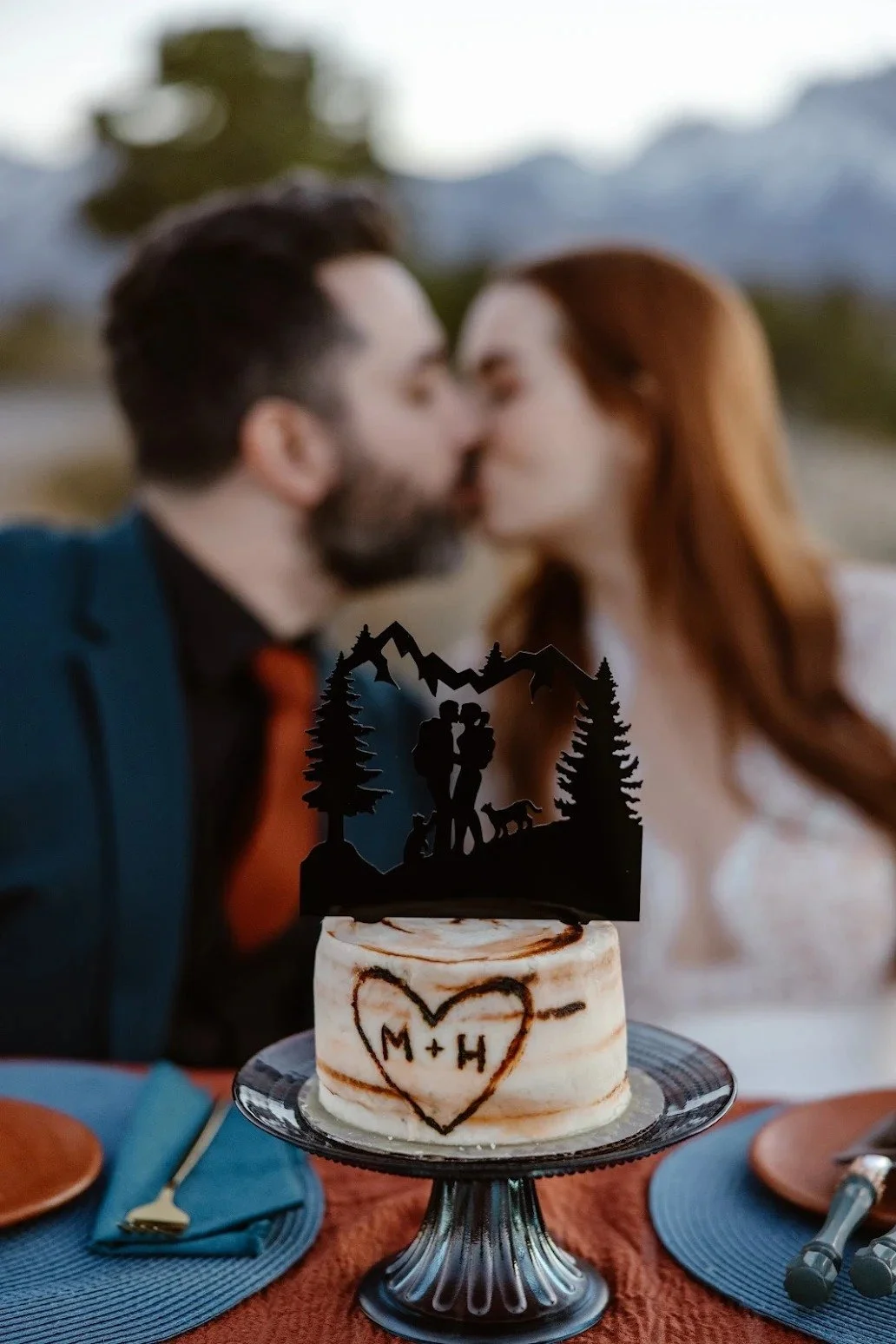 Couple Kissing behind their Aspen Tree Cake