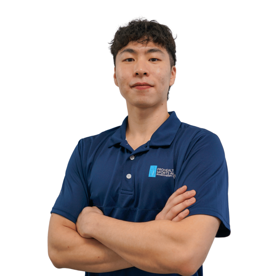 Man in a blue polo shirt crossing his arms, white background.