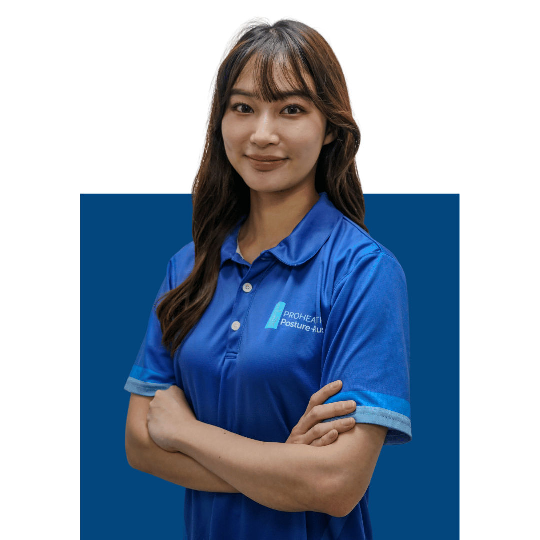 A woman with long brown hair wearing a blue polo shirt with a company logo, standing with arms crossed against a white background with a blue rectangle behind her.