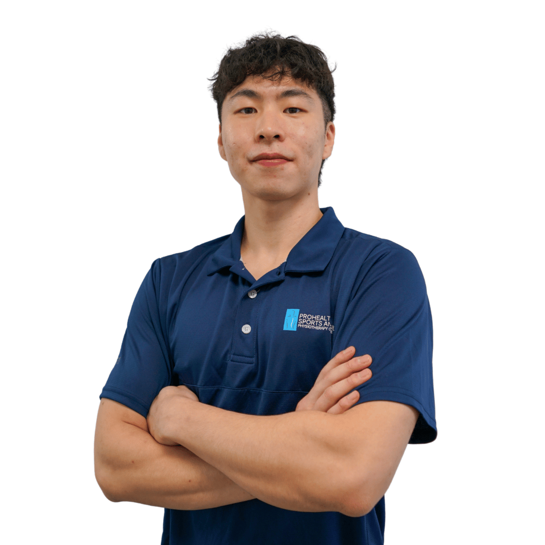 Man in a blue polo shirt crossing his arms, white background.
