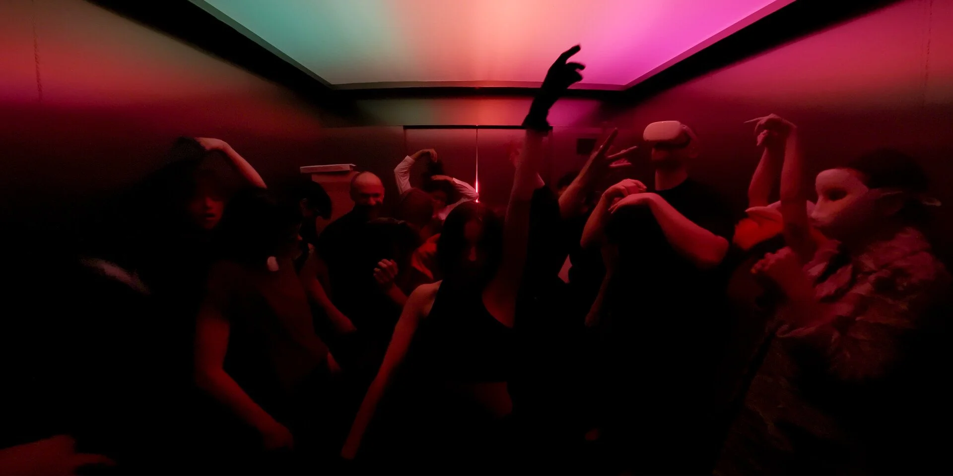 A crowded lift or elevator, descending to the depth as everyone dances.