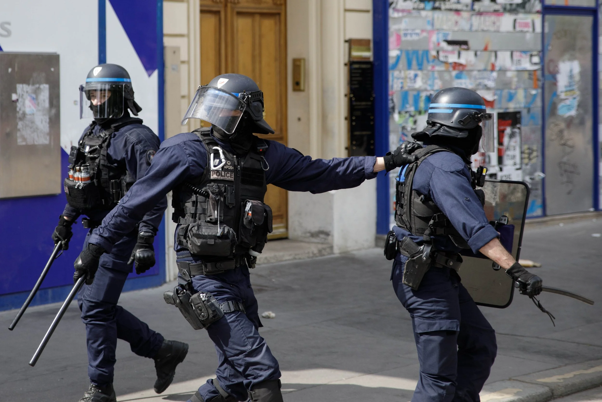 FRANCE, Paris 01 May 2026: 
Riot Police look in different directions whilst trying to avoid flying objects thrown by protesters. Protests in Paris march through the streets on May 1st for International Worker’s Day. In previous years the event has at