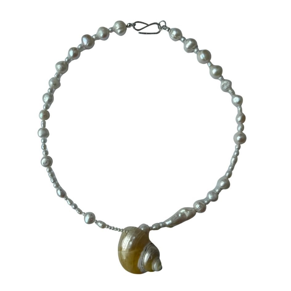Pearl necklace with a large shell pendant.
