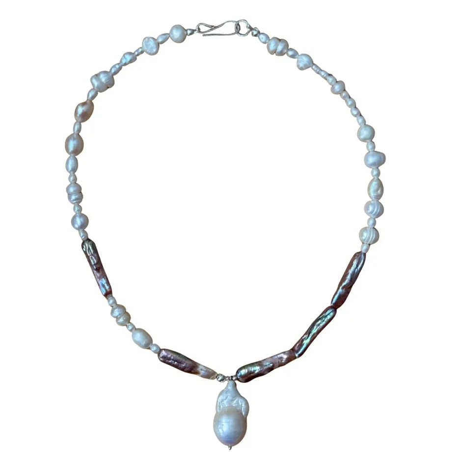 Pearl necklace with large white pendant, featuring irregularly shaped pearls and tube-shaped dark pearls.