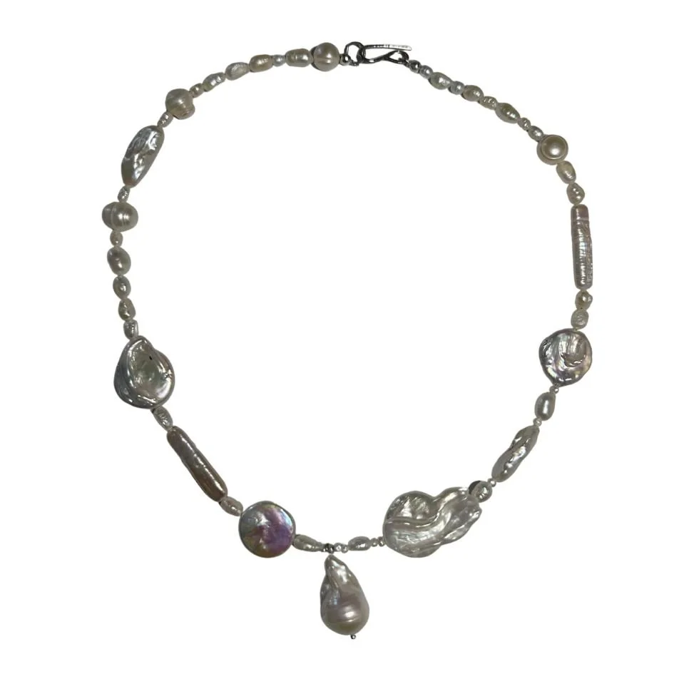 Necklace made of various pearl and baroque pearl beads with a metal clasp.