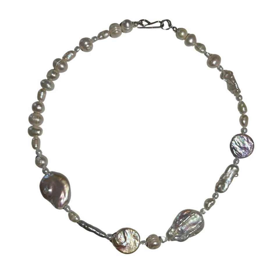 Pearl necklace with irregularly shaped pearls and a silver clasp.