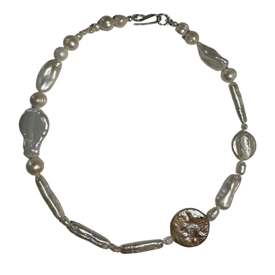 A necklace made of various shaped and sized pearls and beads.