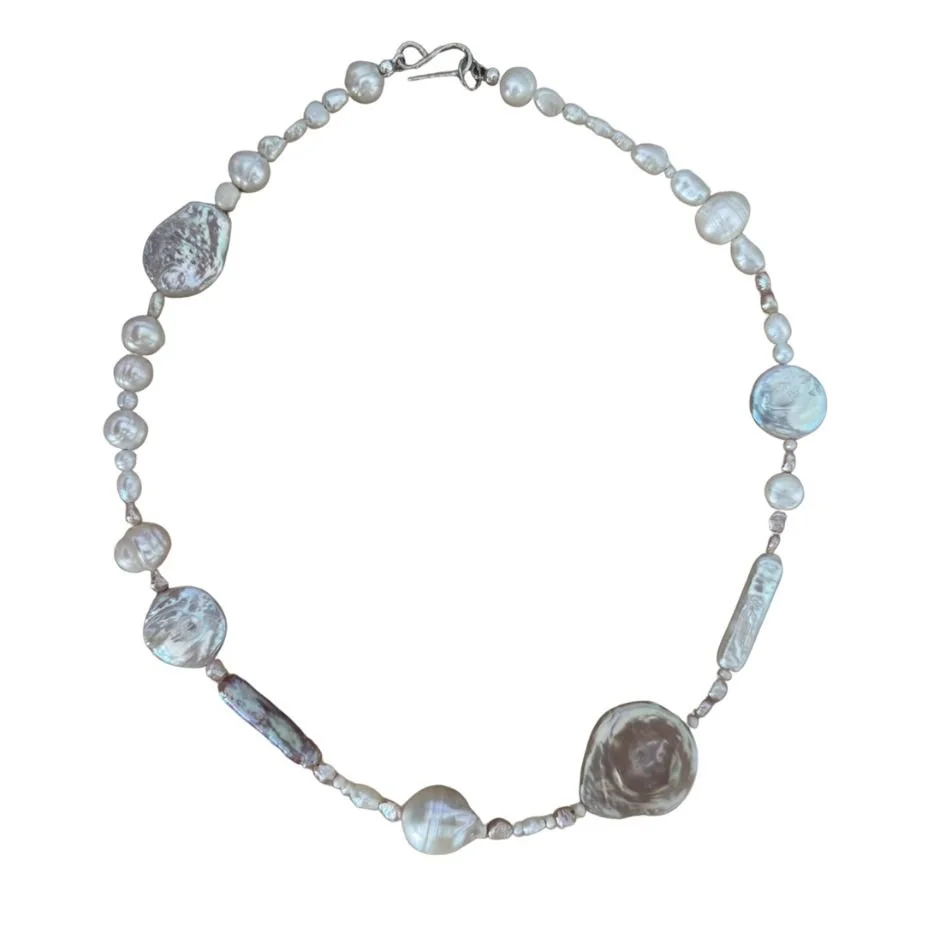 Pearl necklace with variously shaped and sized white and gray pearls.