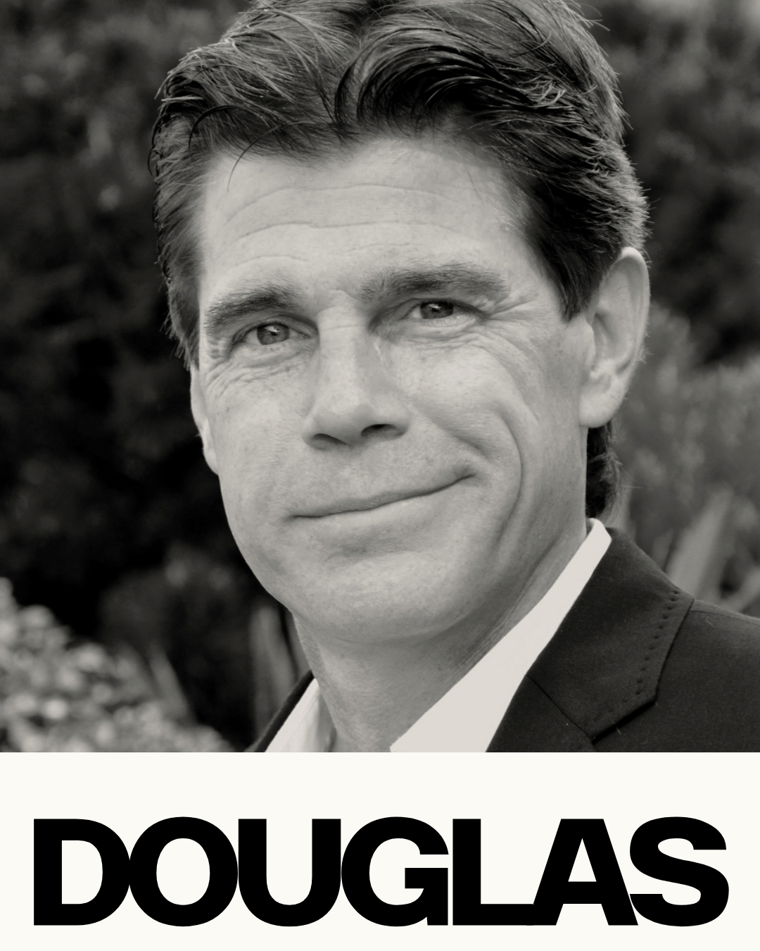 Black and white photograph of a man in formal attire with slicked-back hair, smiling, outdoors background, with the name "DOUGLAS" in bold letters at the bottom of the image.