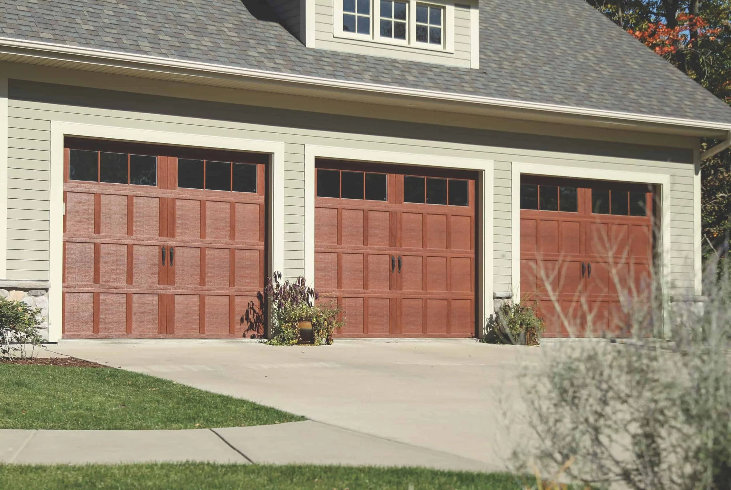 three light brown wood garage doors