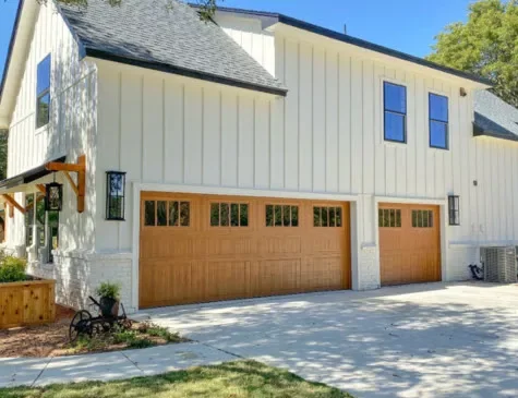 modern home with wood tone garage doors