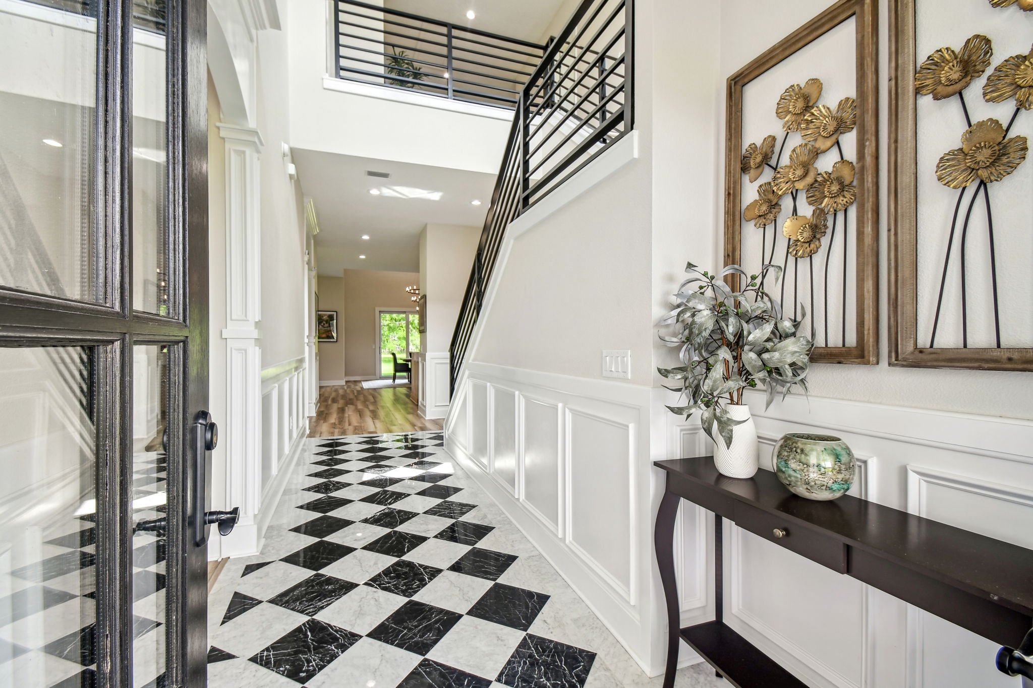 First impressions matter&mdash;and this one&rsquo;s unforgettable.

🖤 Classic meets contemporary in this grand foyer with checkerboard floors and wainscoting detail.

#AnemoneInteriors #CheckerboardFloors #EntryWayDesign #FloridaDesigner