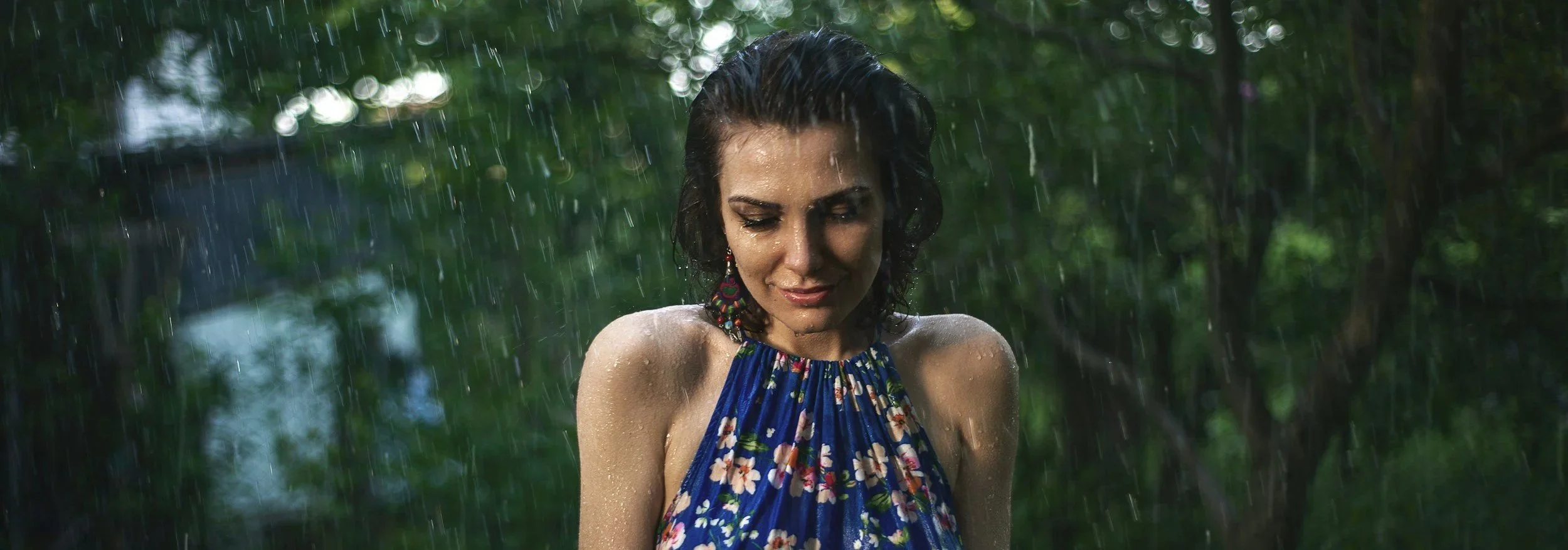 Woman standing in the rain at the end of summer