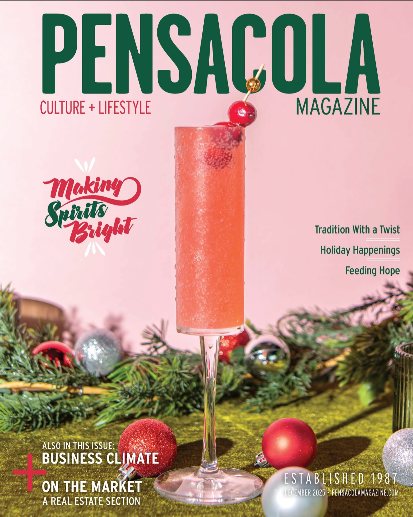 Cover of Pensacola Magazine with a pink background, featuring a pink cocktail in a tall glass garnished with a cherry and a gold skewer. Decorated with Christmas ornaments and greenery at the base.