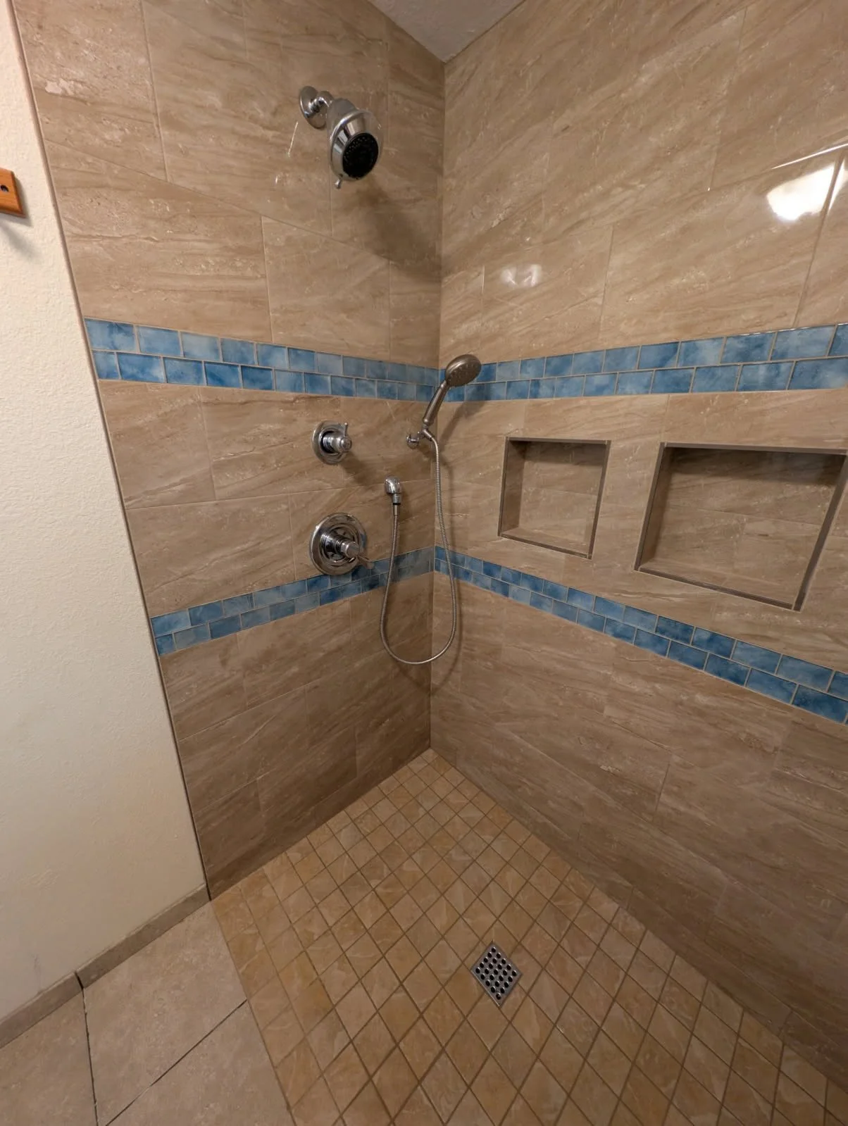 brown curbless shower with niches