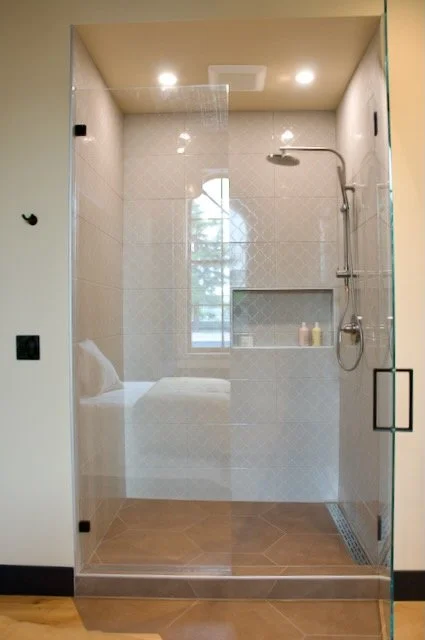 White tile shower with double niche