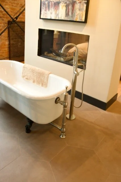 Hexagon brown tile floor around clawsfoot tub