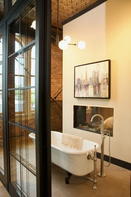 Octagon brown tile floor around clawsfoot tub