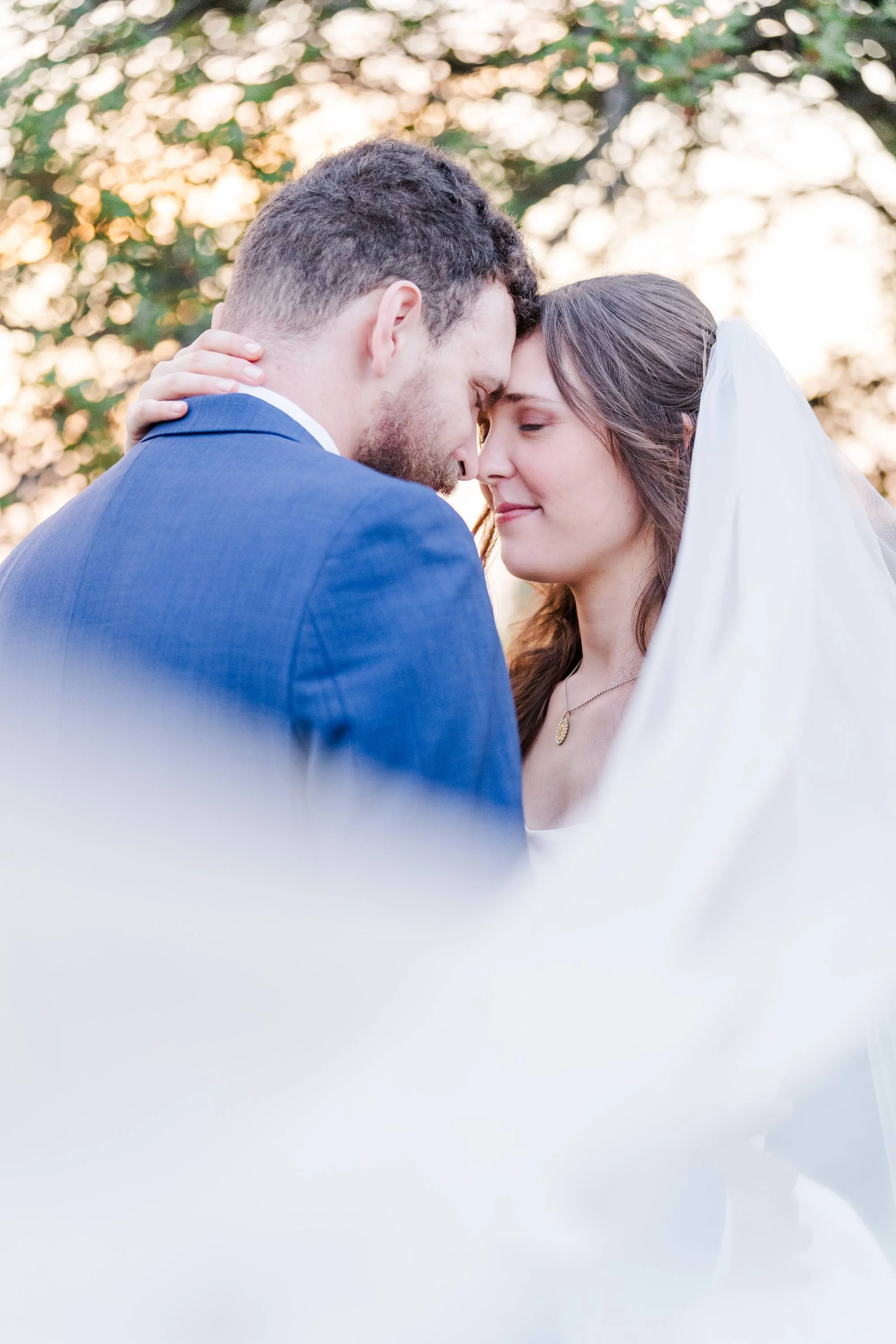 bride and groom holding heads together