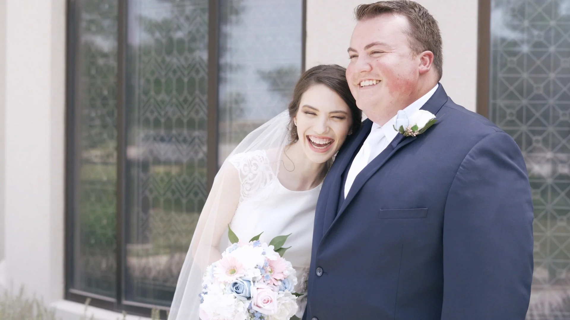 Bride and groom smiling for a photo taken by Tess Sousek