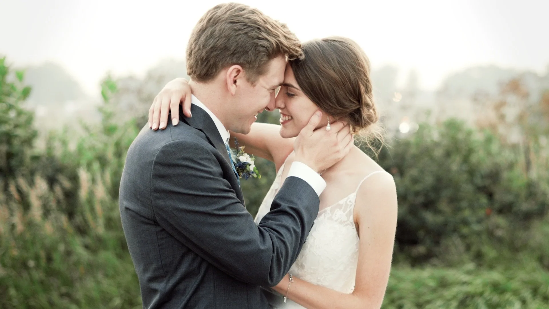 Bride and groom with heads together smiling