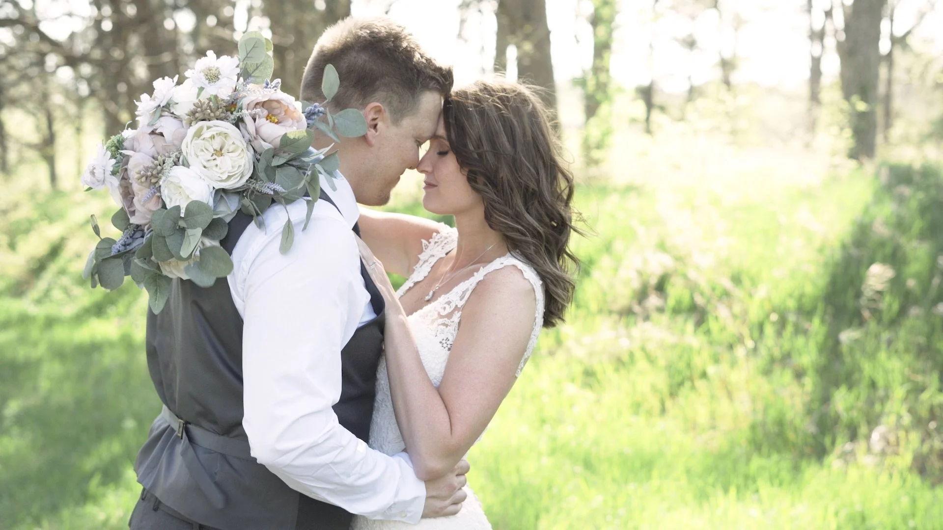 bride and groom posing in the woods for a photo taken by Tess Sousek