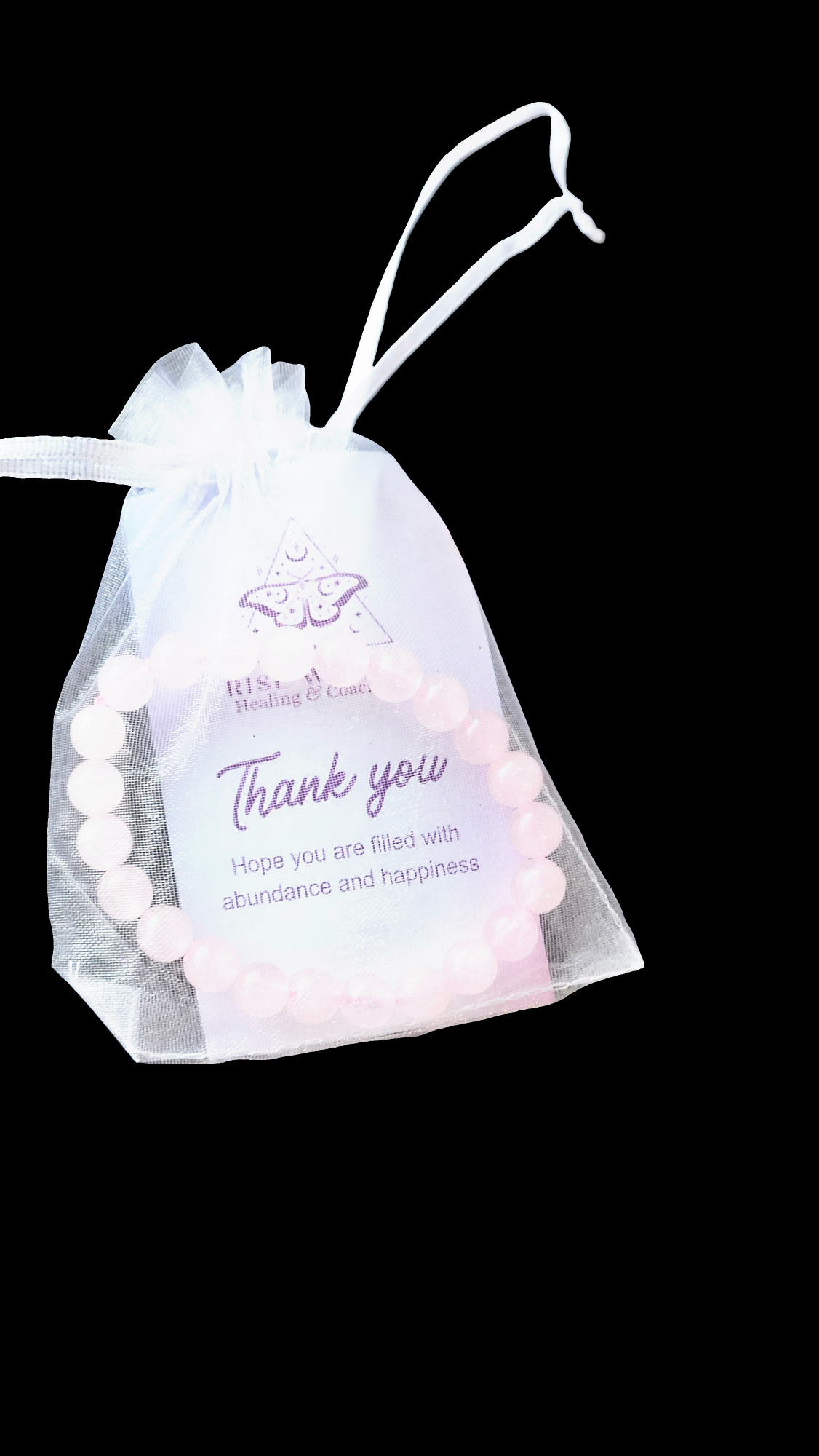 Pink beaded bracelet inside a white organza gift bag with a thank you message, on a black background.