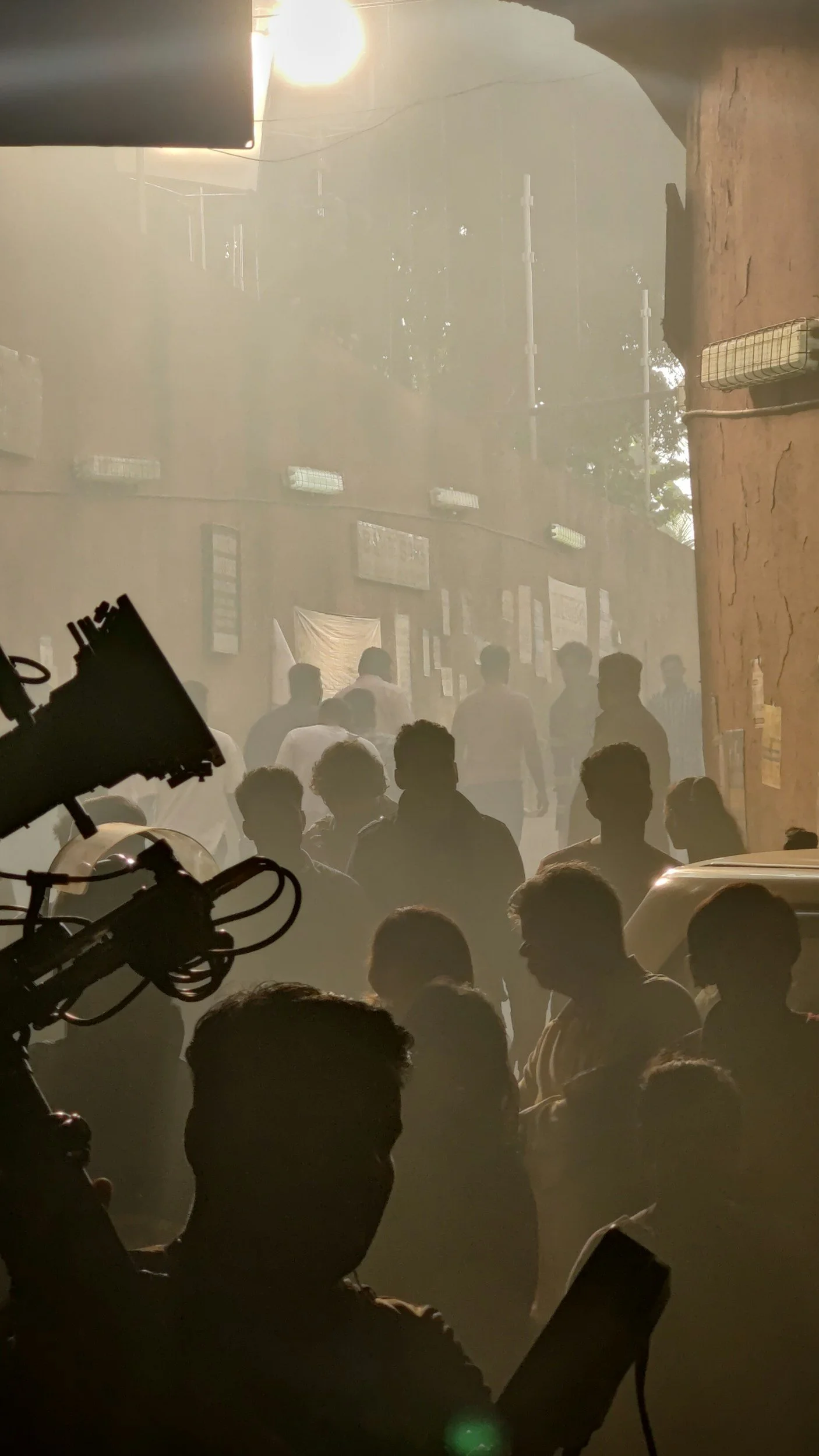 Silhouettes of people gathered on a film set.