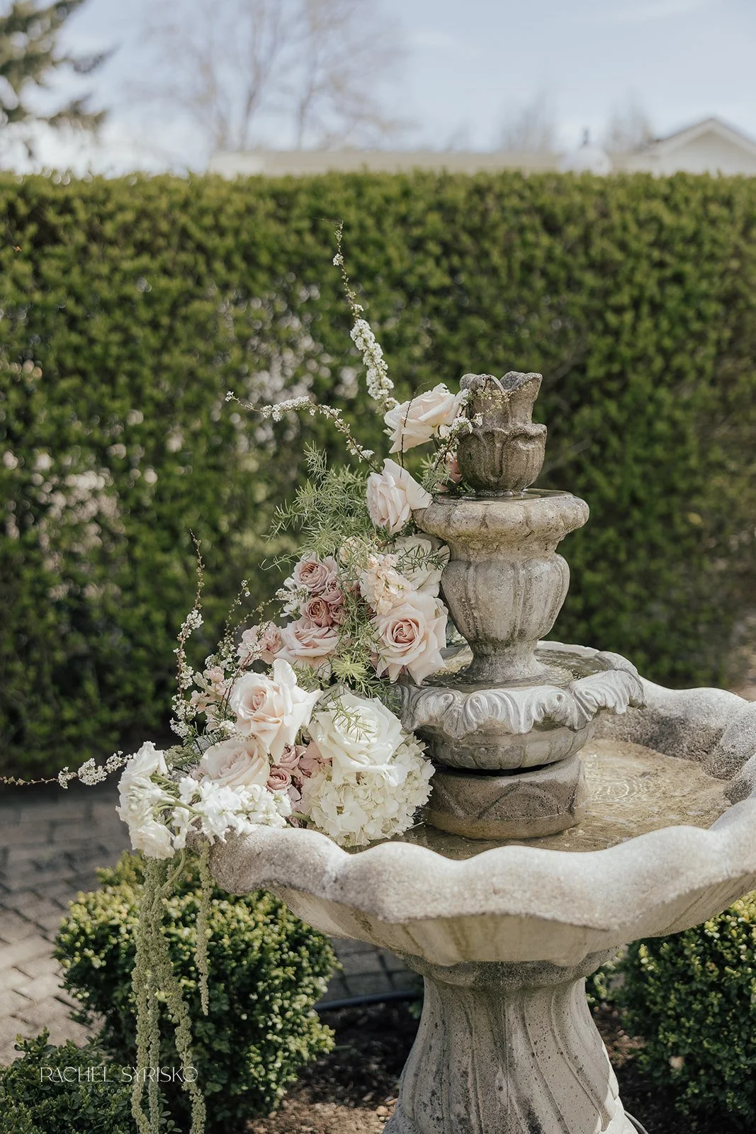 cascading florals in a stone fountain
