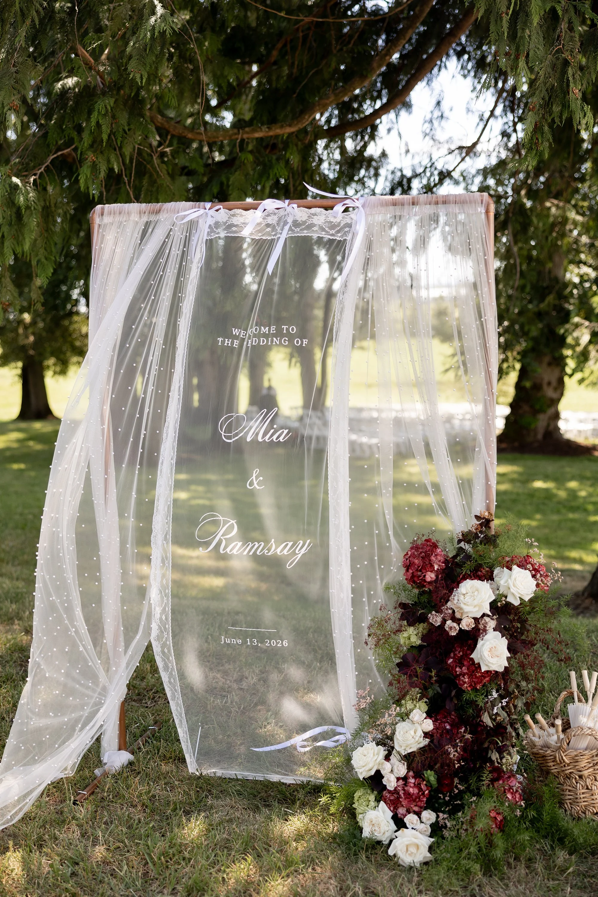 Sheer curtain embroidered with bride and groom names and wedding date behind