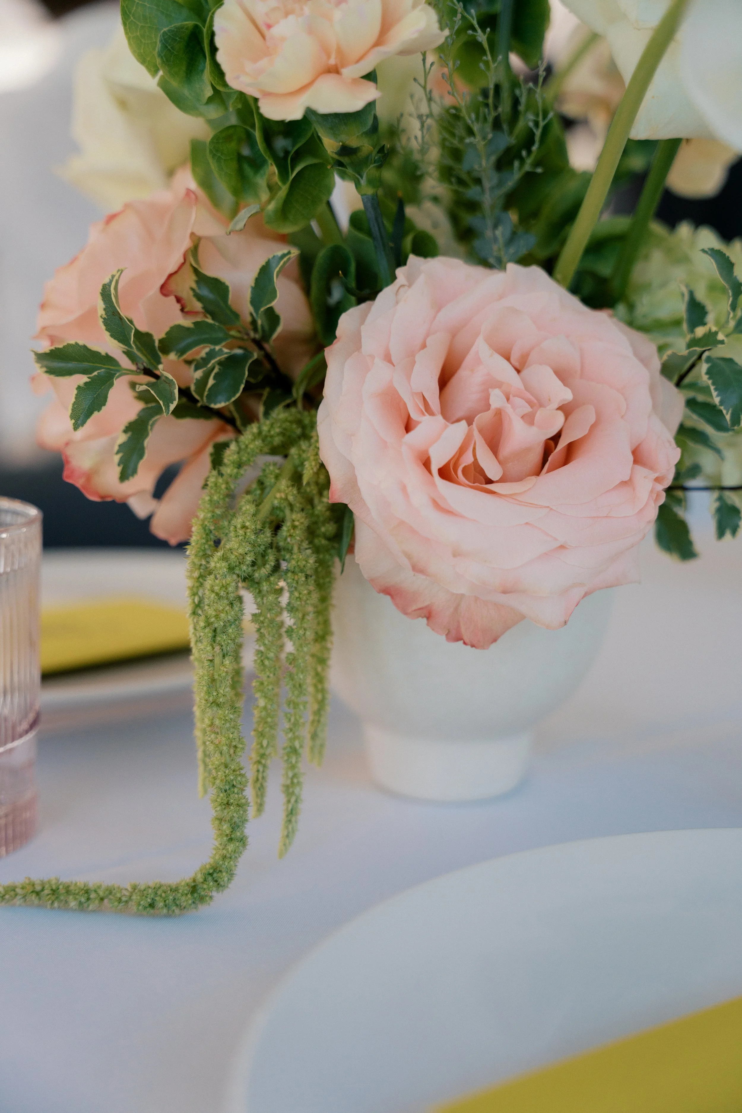 A long wedding reception table with floral arrangements.