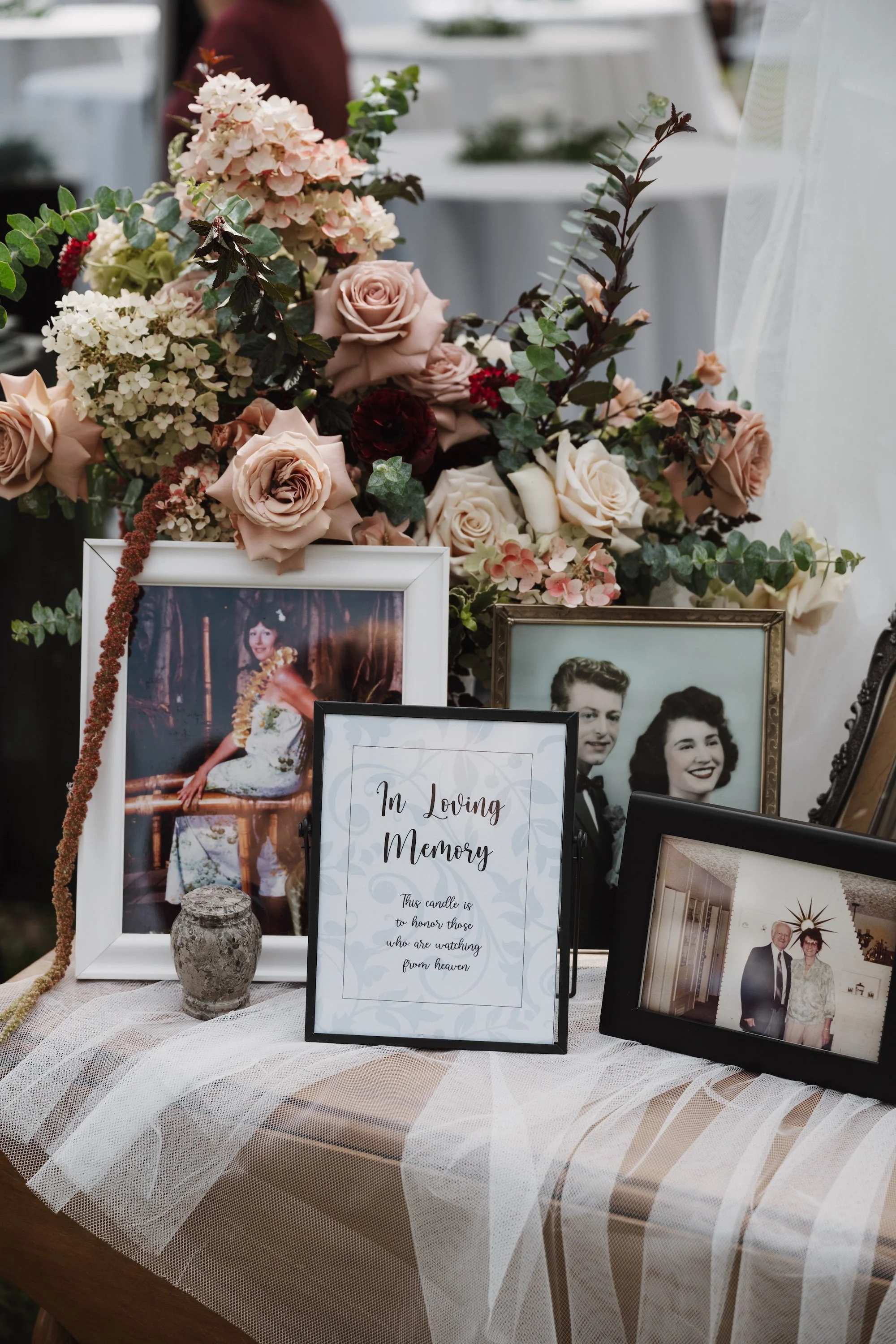 in memoriam table at wedding with mauve and cream flowers and photos