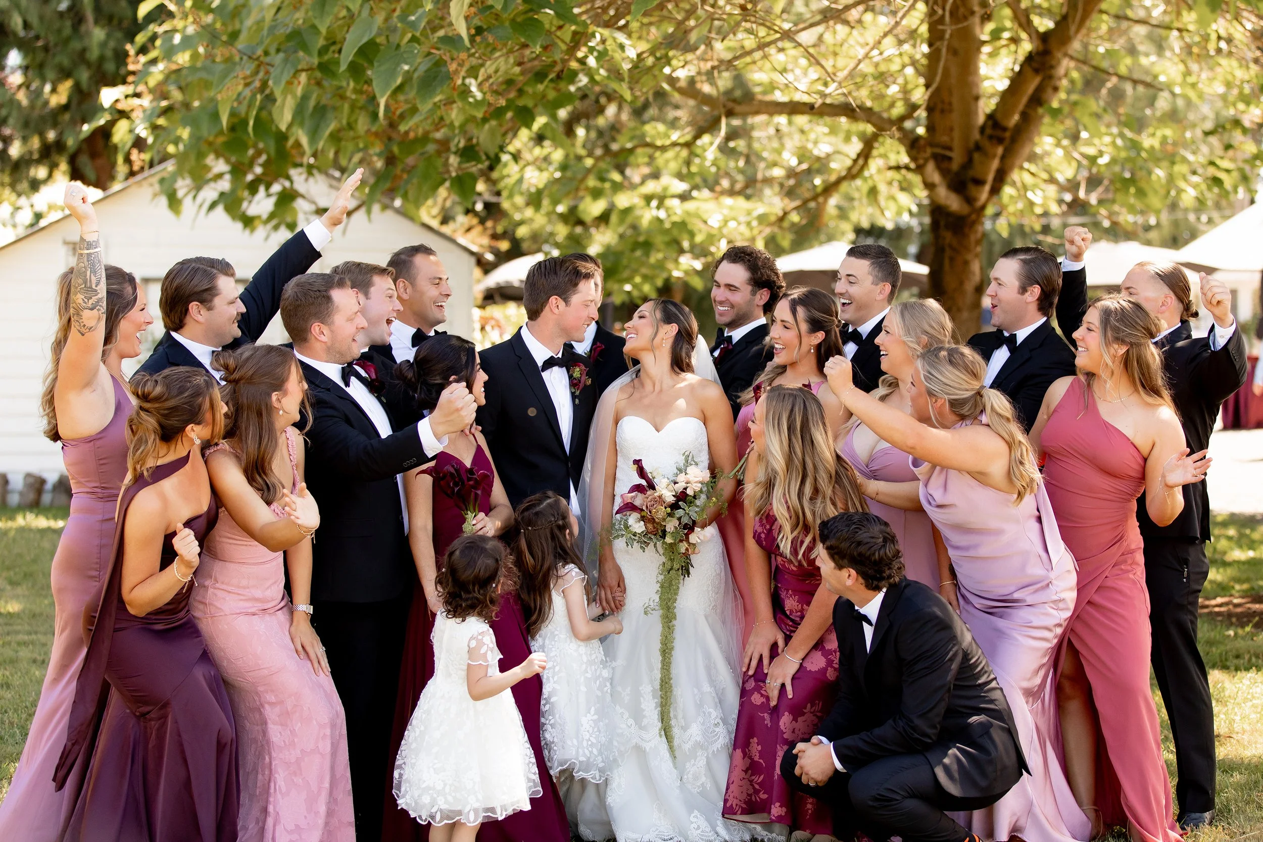 wedding party surrounding the happy couple
