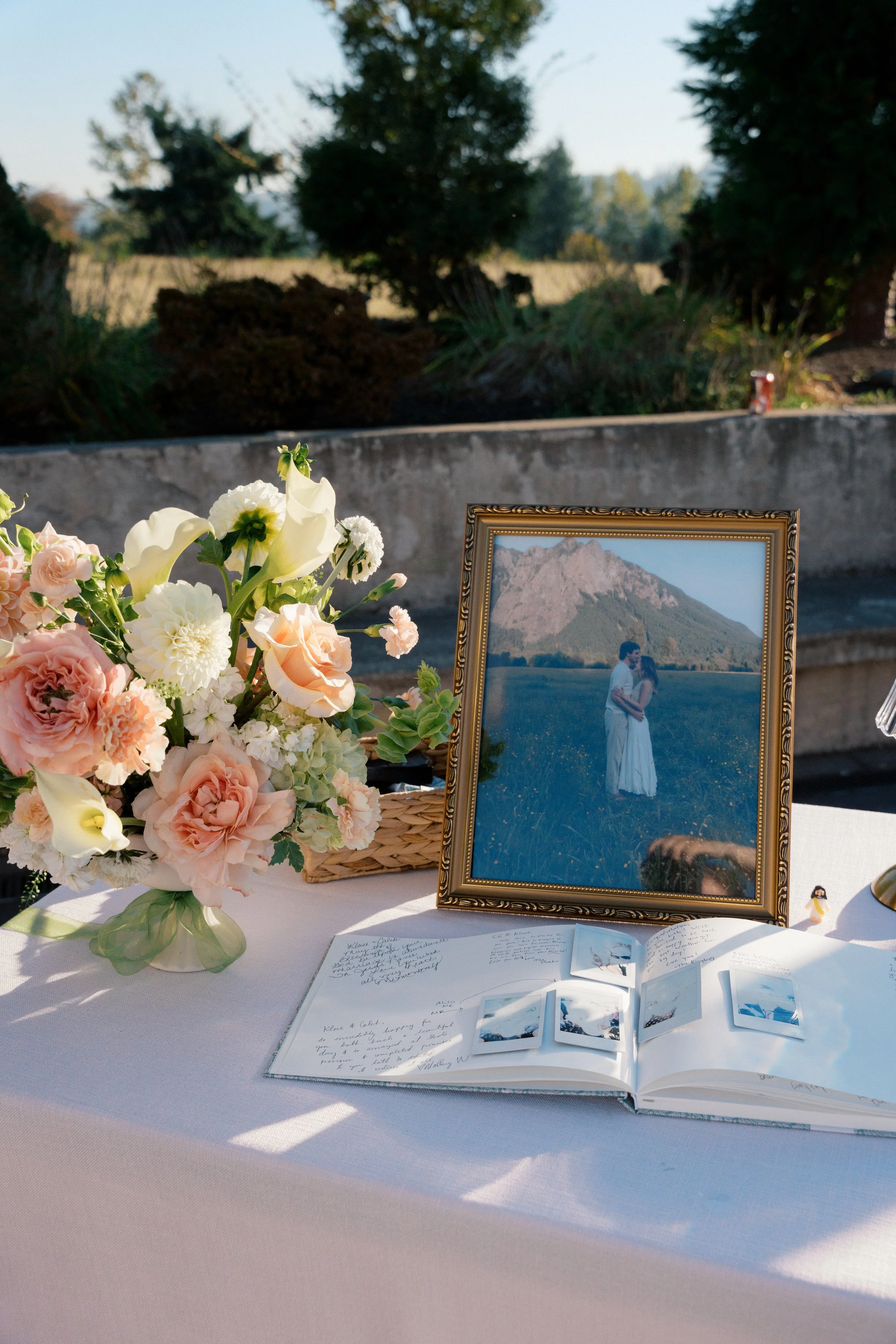 wedding guest book with floral vase.