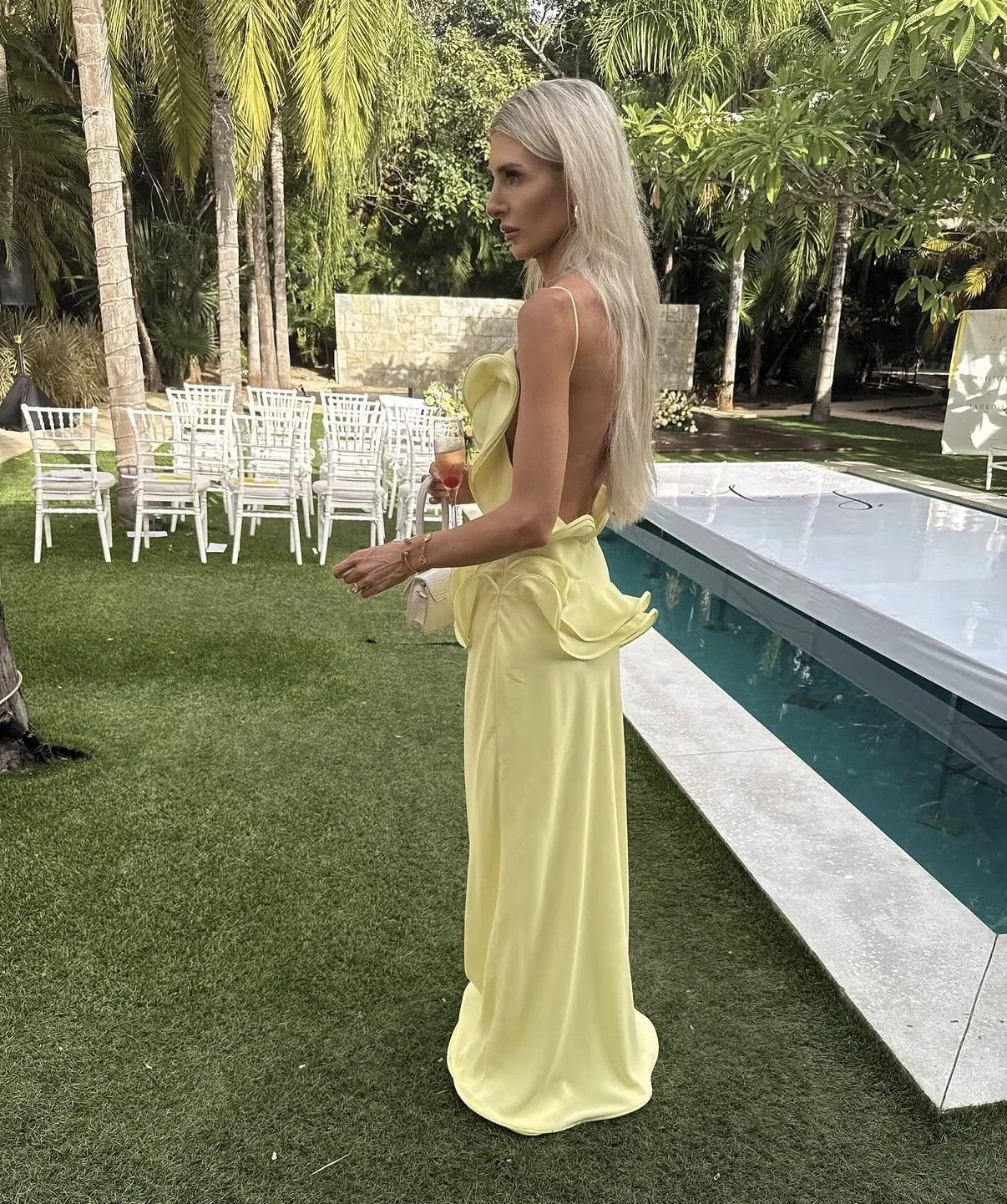 Styled by Virginia, destination client in yellow dress at a tropical wedding