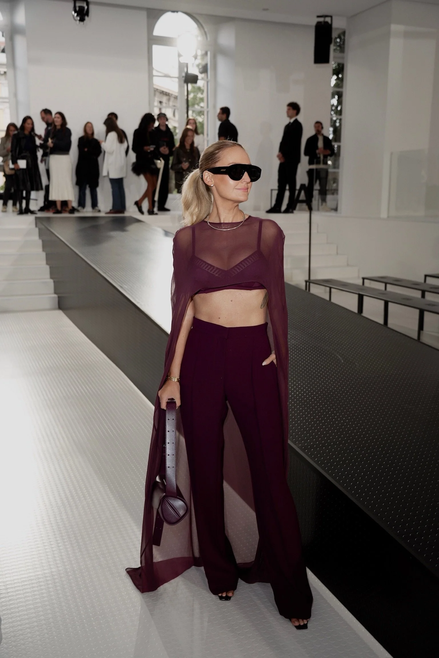 Virginia Bundy, owner of Styled by Virginia, featured in a plum three piece set at a fashion show in Italy