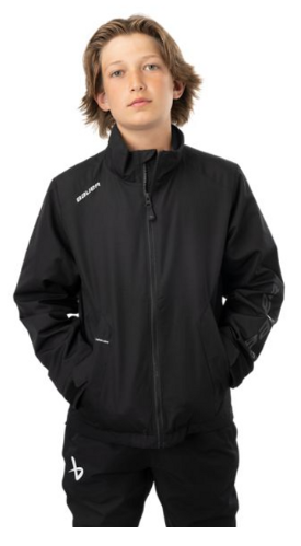Teenager wearing a black Nike sports jacket with hands in pockets.