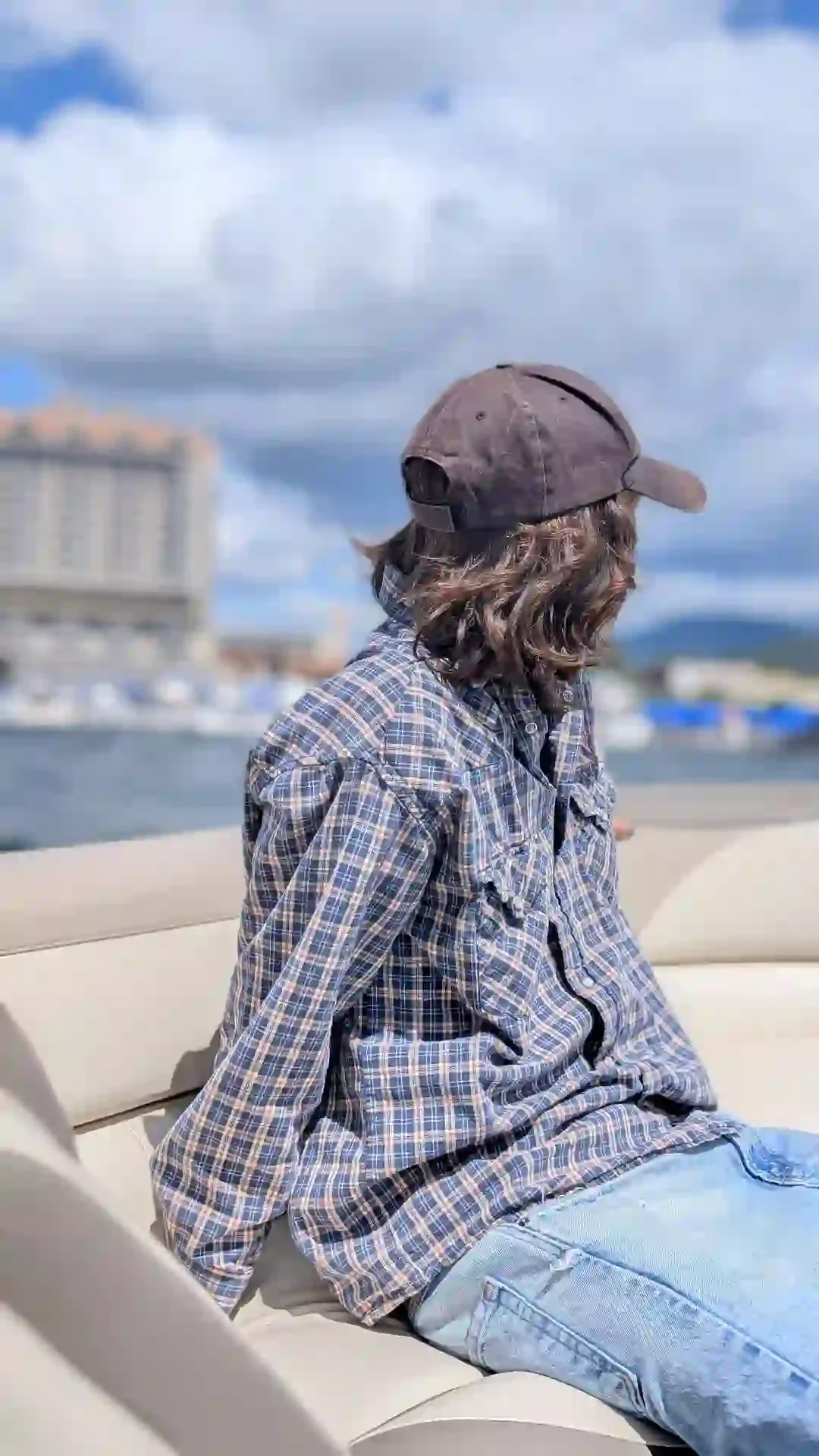 The back of a young man looking out over the water